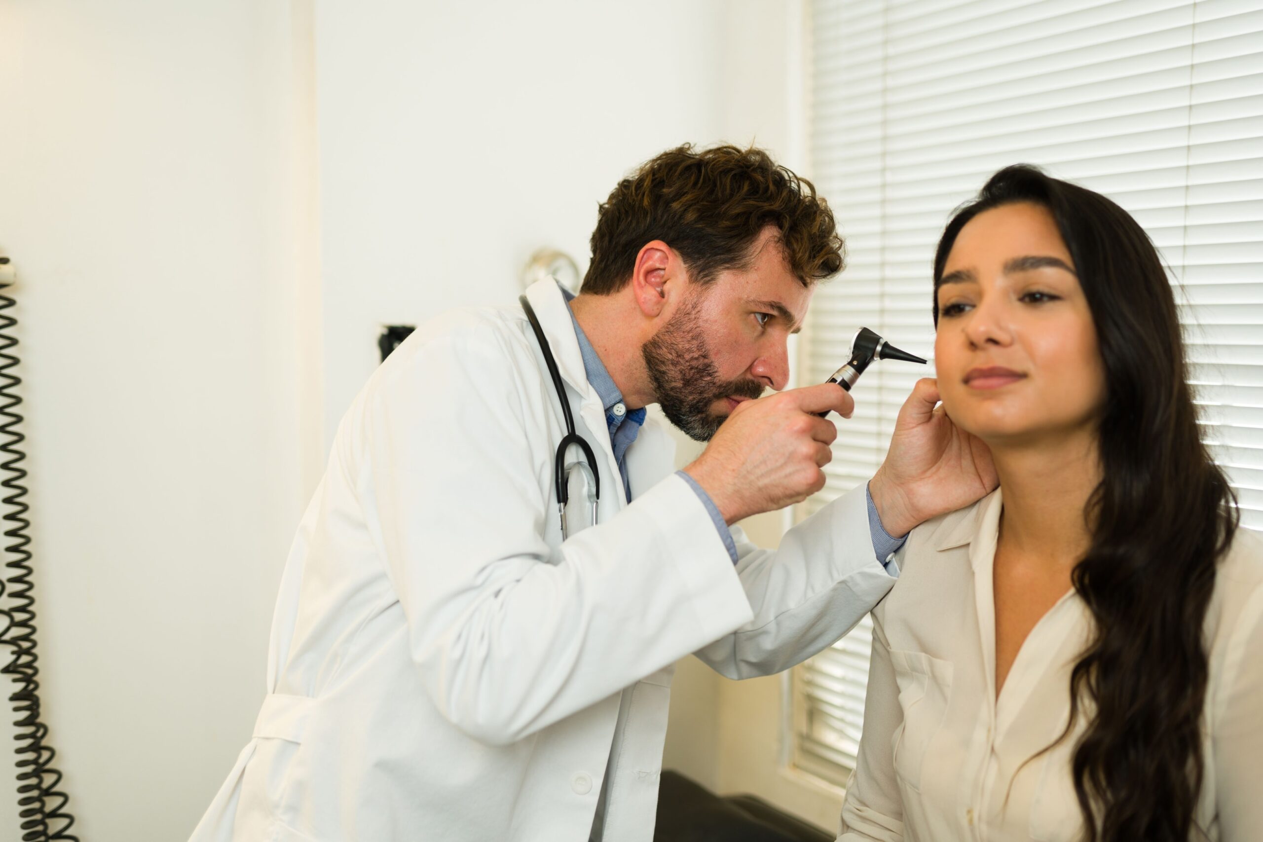 Doctor checking out patients ear infection