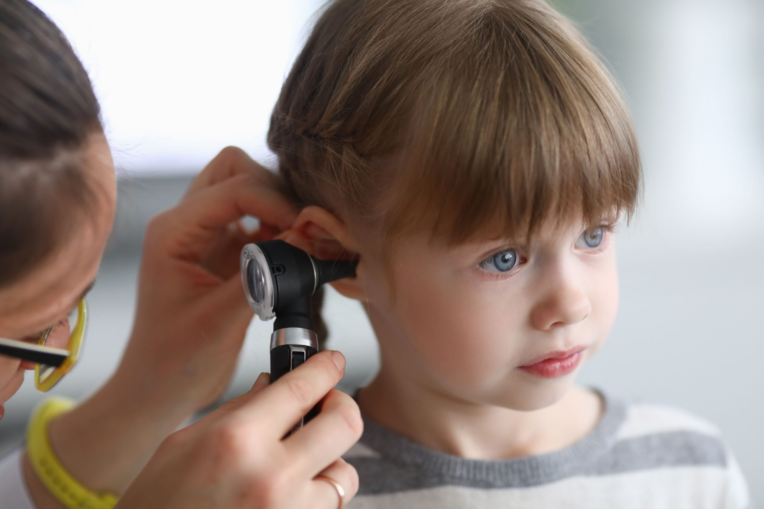 Illustration of a child getting his ear checked out