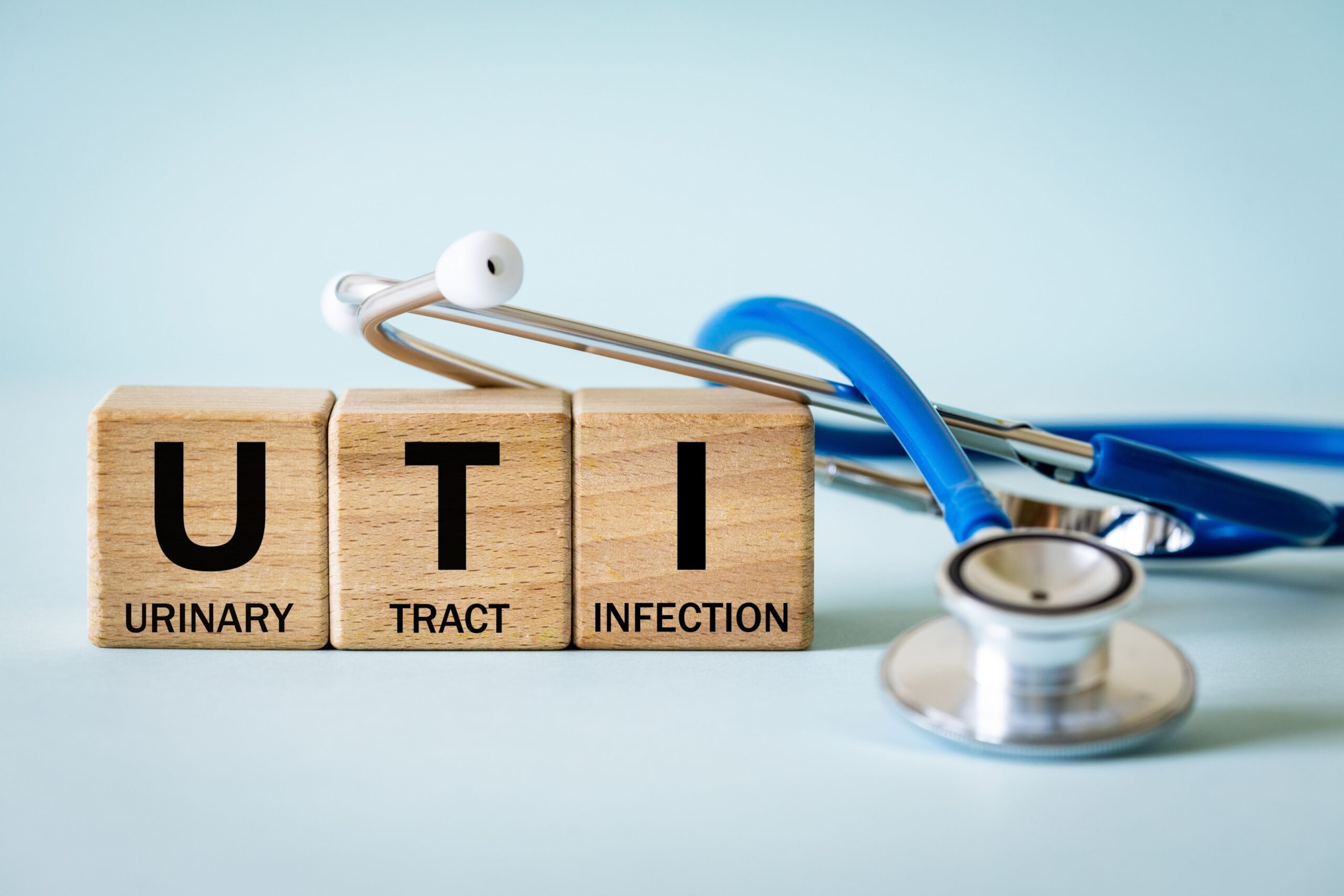 Urinary Tract Infection spelled out in blocks alongside a stethoscope