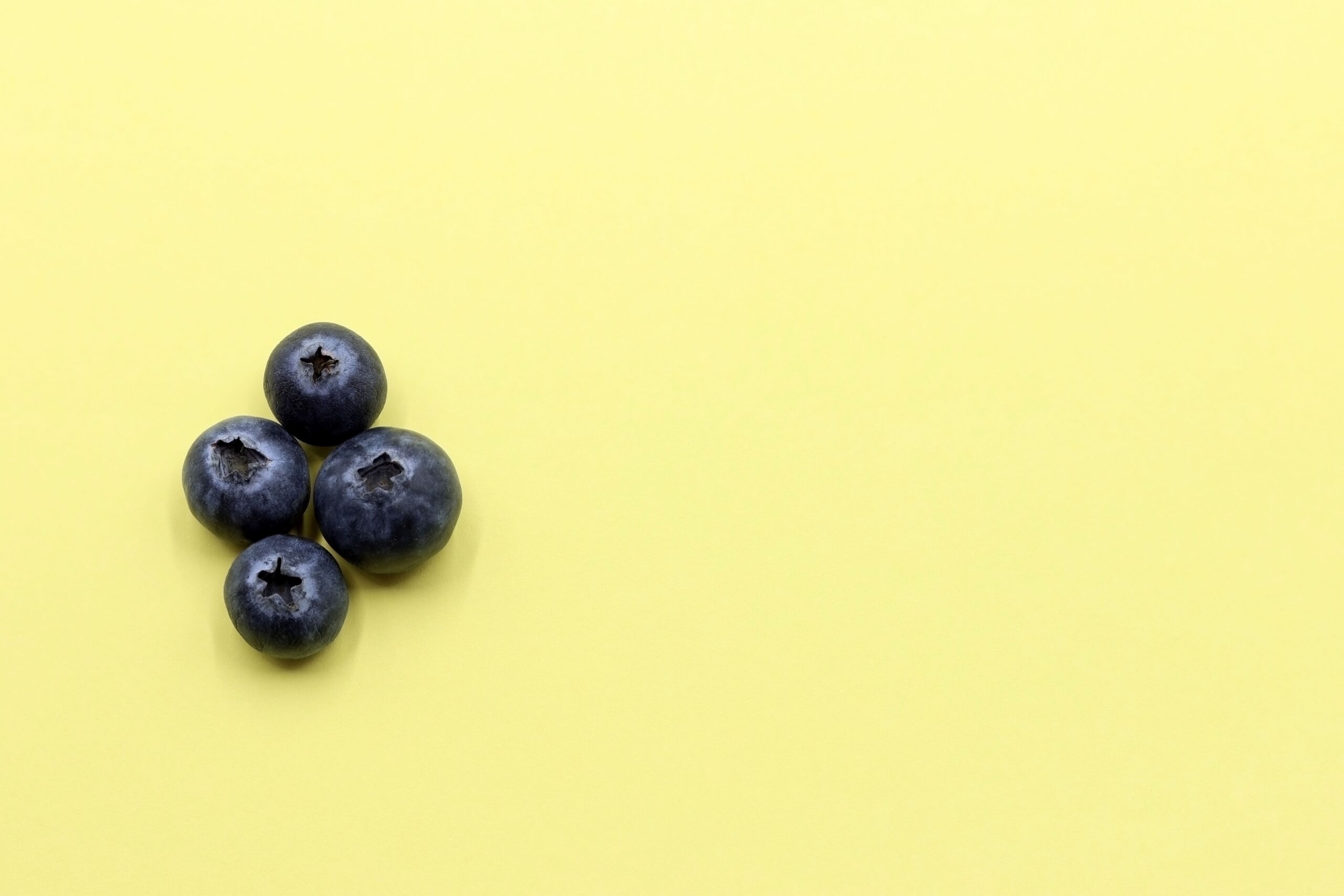 Blueberries on a yellow sheet of paper