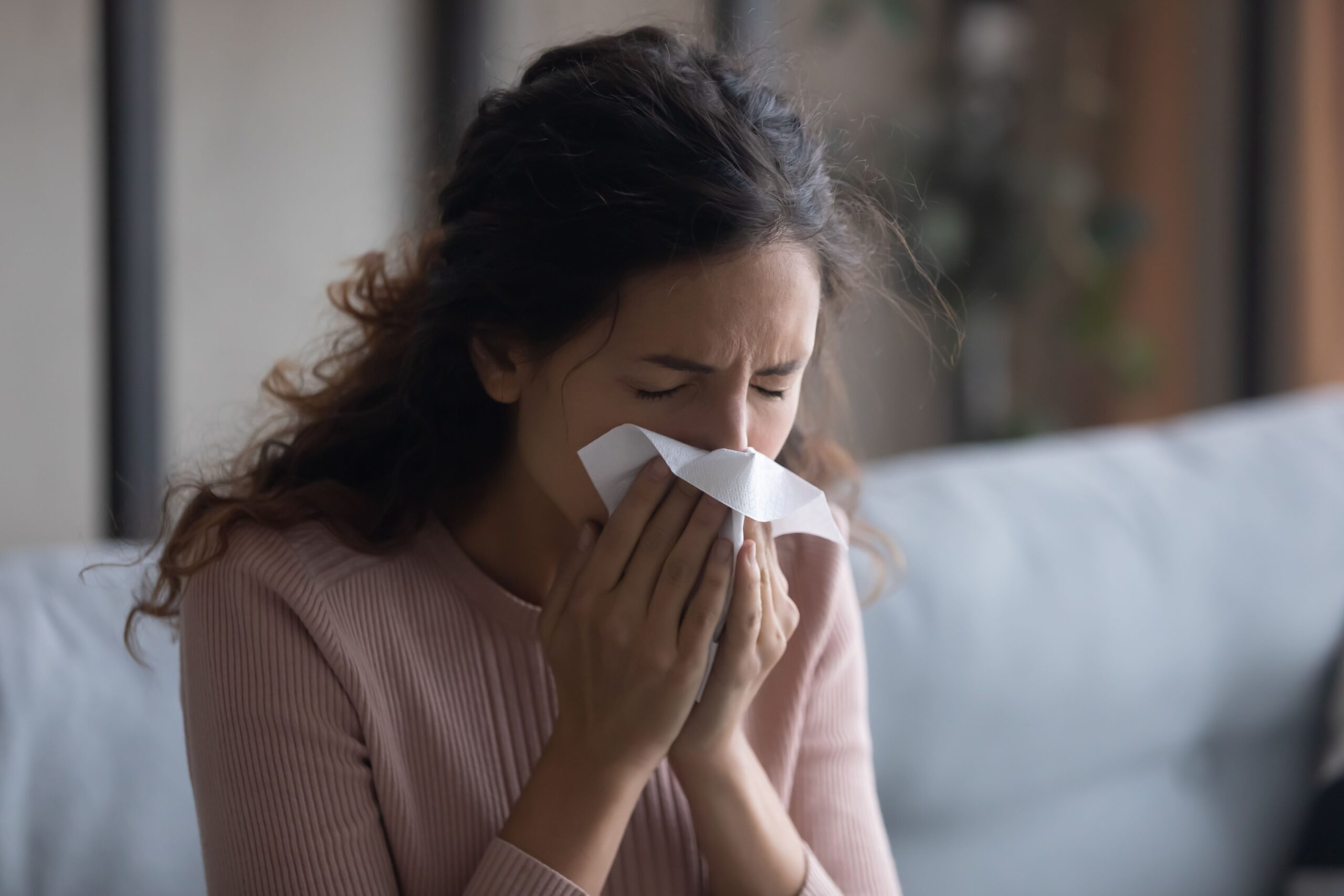 Woman experiencing allergy symptoms